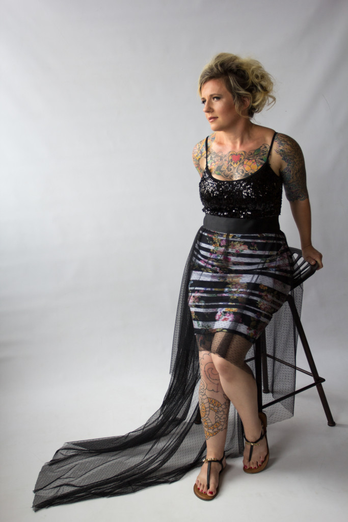 glamour. tattoos. blonde. evening dress. black.